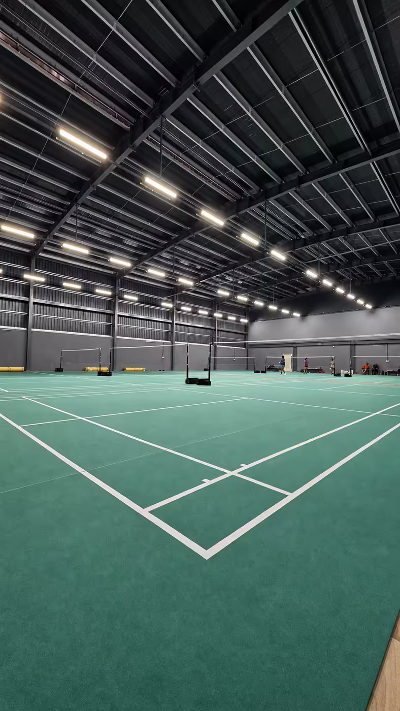 Fresh white court lines on the red badminton flooring at Game Theory Panathur