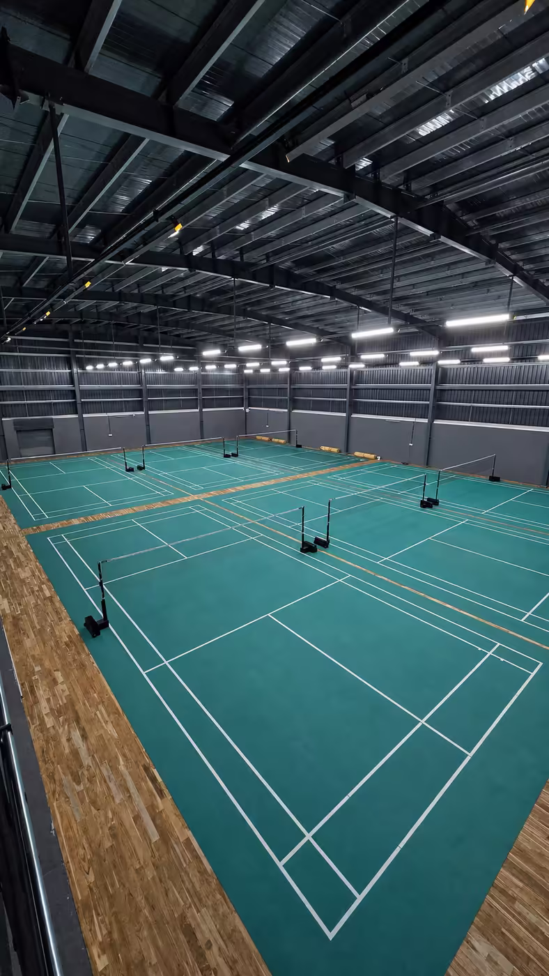 A row of green badminton courts with nets at Game Theory Panathur