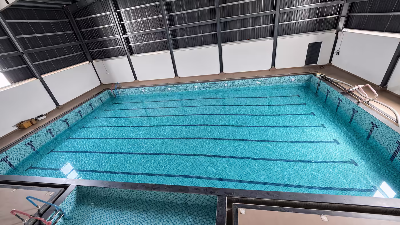 The indoor temperature-controlled pool with red lane ropes at Game Theory Panathur